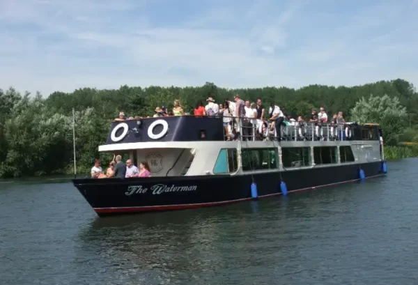 The Waterman boat cruising along the river thames with guests onboard.