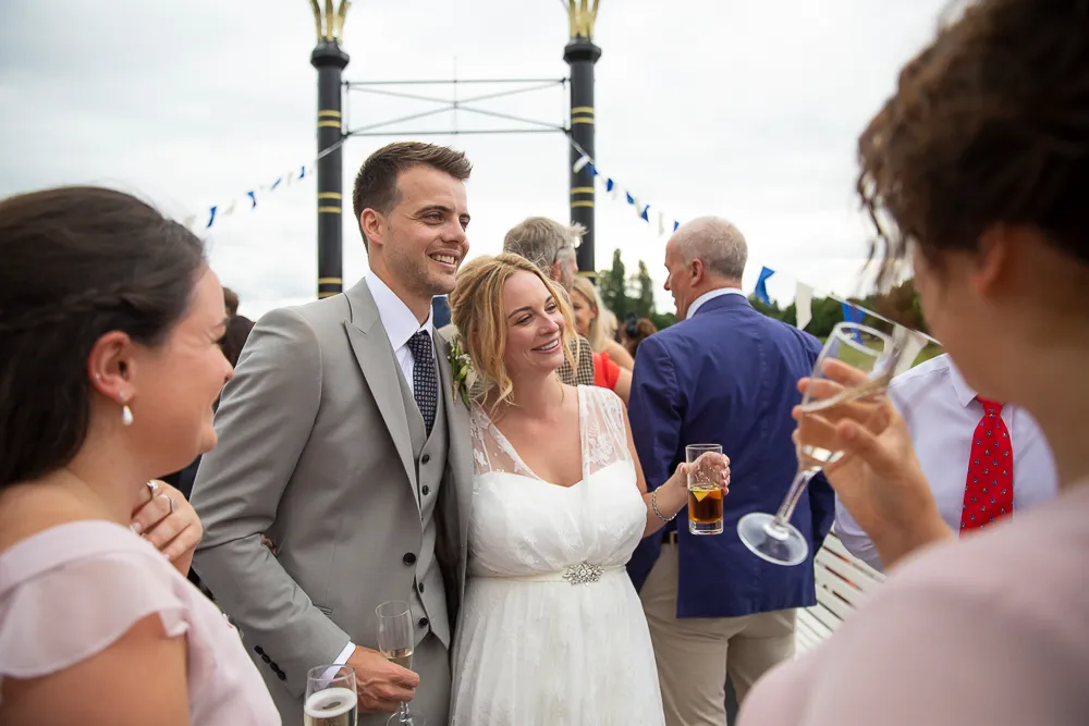 A happy couple on the deck of The New Orleans boat celebrating their wedding day on the river thames in Henley